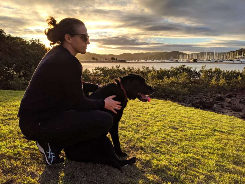 Woman on headland with Labrador