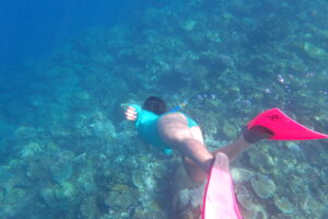 Girl snorkeling at Mana Island reef.