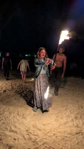 Girl fire dancing on Vanuatu beach at night